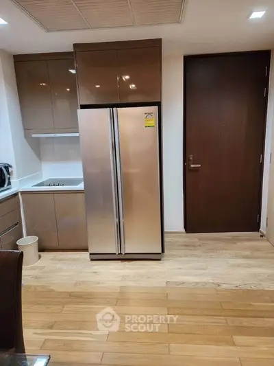 Modern kitchen with sleek cabinets and stainless steel fridge