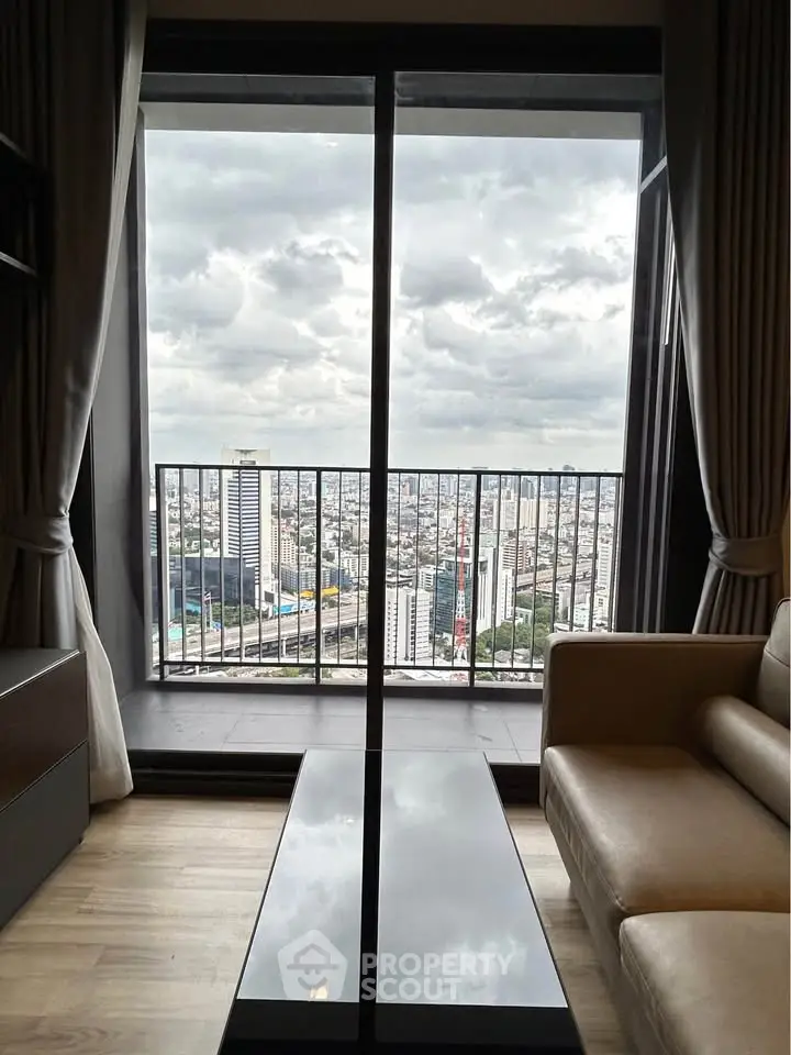 Stunning city view from modern living room with floor-to-ceiling windows and cozy seating.