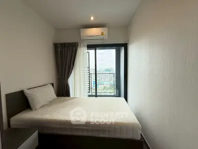 Modern bedroom with city view and balcony access, featuring sleek design and natural light.