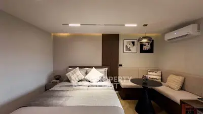 Modern bedroom with cozy seating area and stylish decor