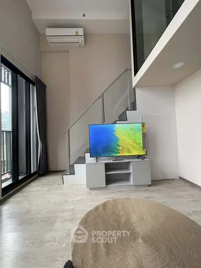 Modern loft apartment with mezzanine, large windows, and sleek interior design.