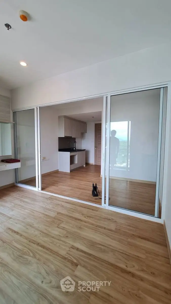 Spacious modern apartment with sliding glass doors and wooden flooring