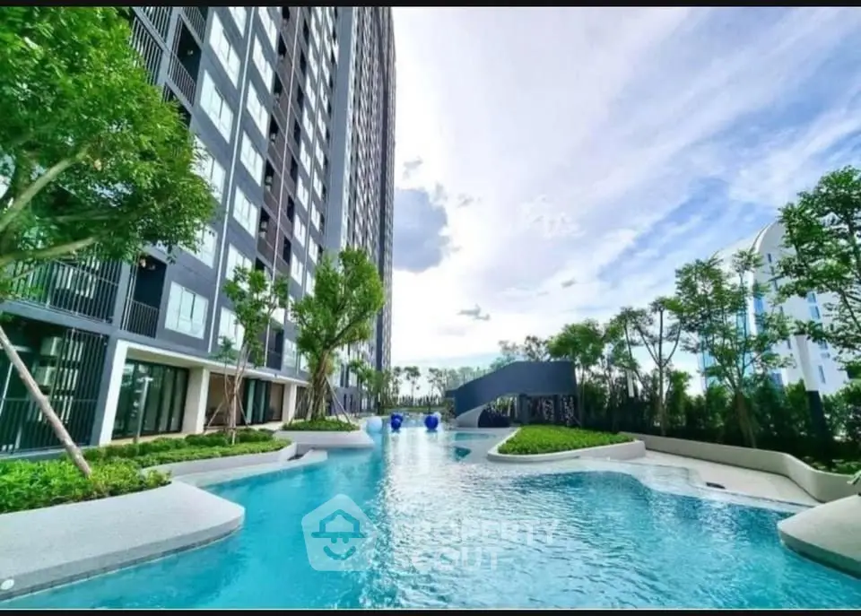 Luxurious condominium with stunning pool and lush greenery, perfect for modern living.