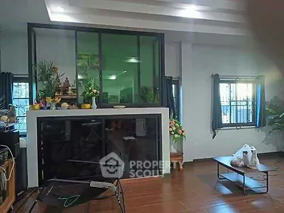 Spacious living room with modern decor and large windows for natural light.