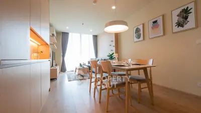 Spacious modern living and dining area with stylish decor and natural light.