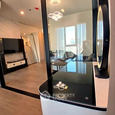 Modern living room with sleek design and large windows offering natural light.