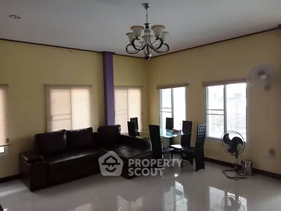 Spacious living room with modern furniture and large windows for natural light.