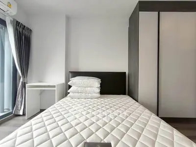 Modern bedroom with sleek wardrobe and large window for natural light