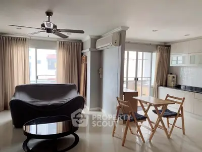 Spacious living room with modern furniture and natural light in a stylish apartment.