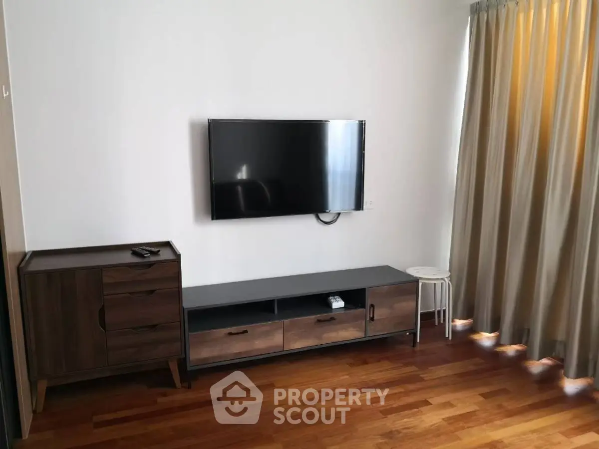 Modern living room with wall-mounted TV and stylish wooden furniture