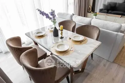 Elegant dining area with marble table and plush chairs in modern living room