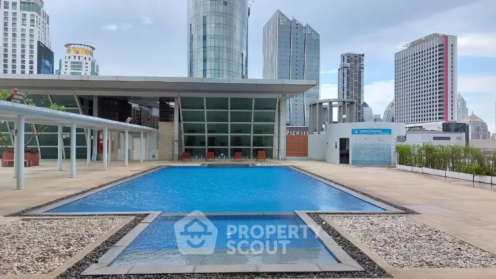 Luxurious rooftop pool with stunning city skyline views in modern urban setting.