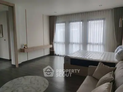 Spacious modern bedroom with large windows and elegant decor