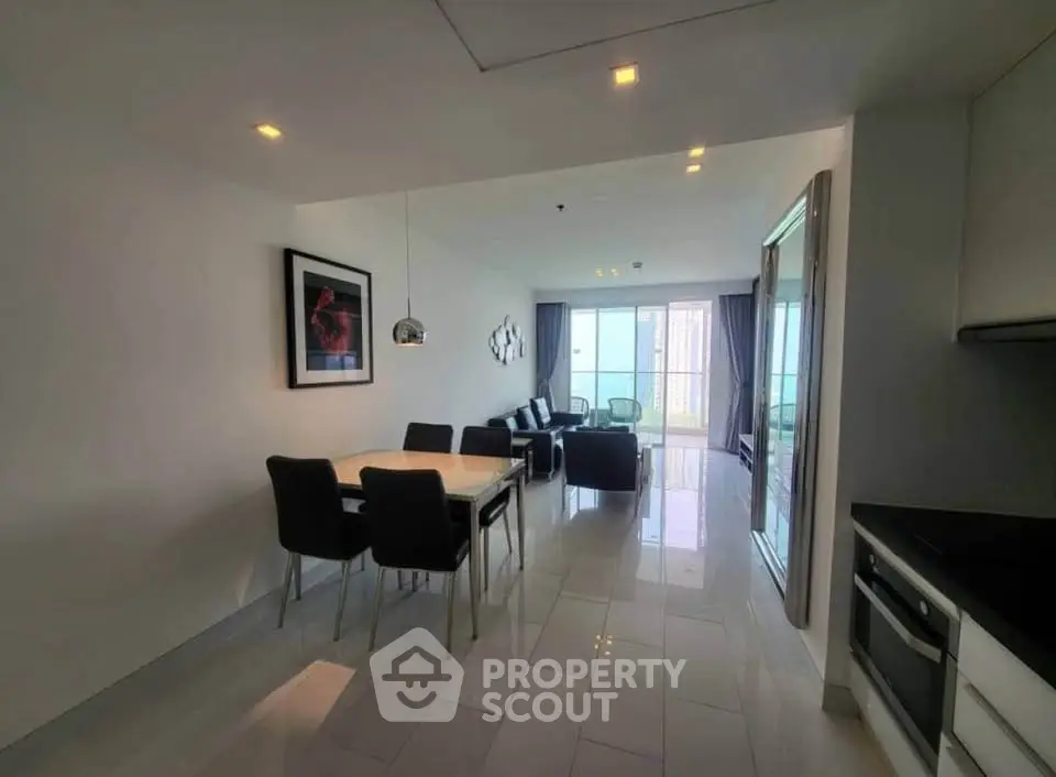 Modern open-plan living and dining area with sleek furnishings and natural light.