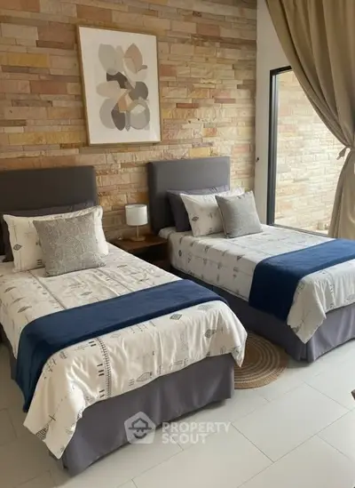 Charming twin bedroom with modern decor and natural light