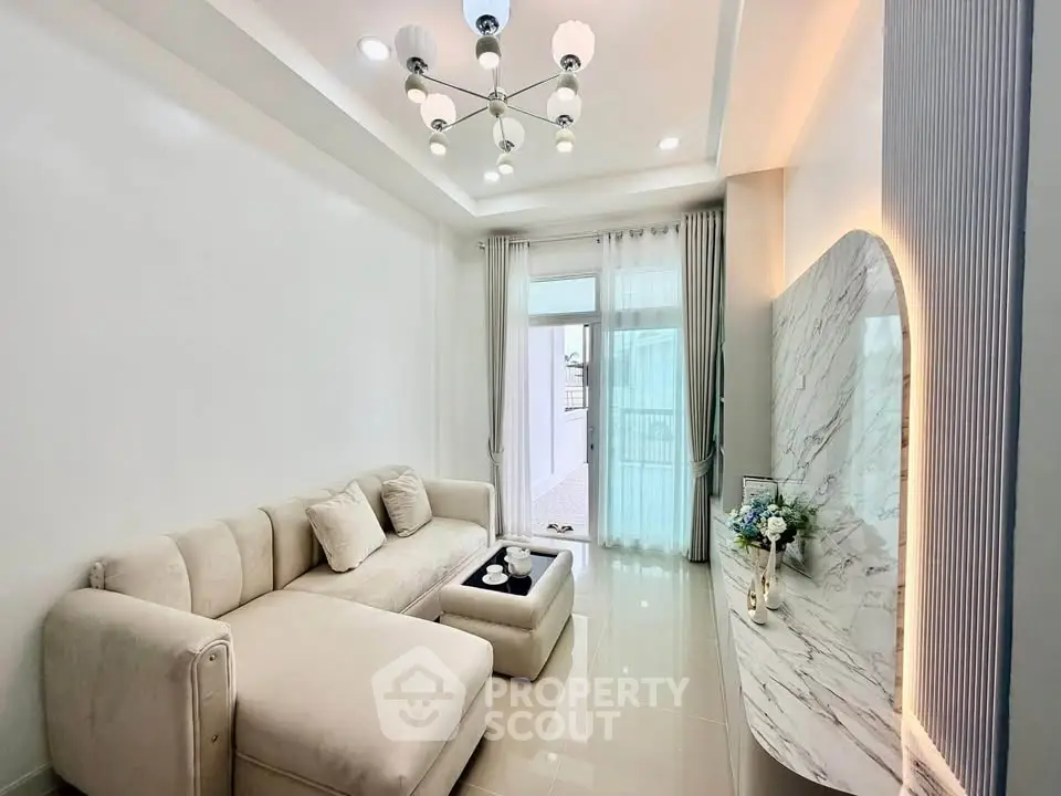 Elegant living room with modern chandelier and marble accents