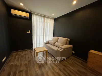 Modern living room with cozy sofa and stylish wooden flooring