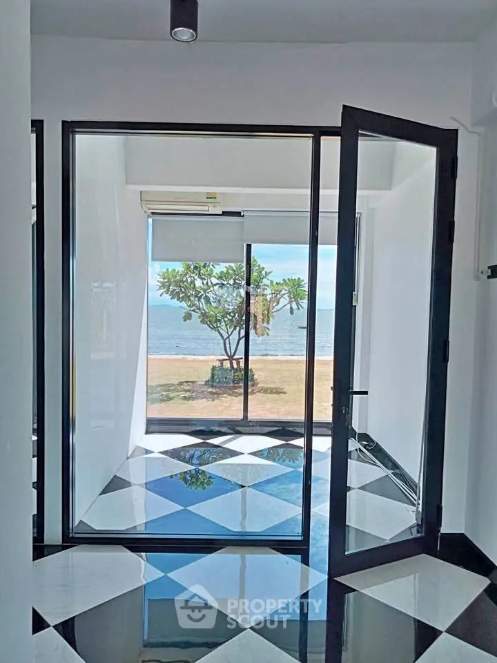 Stunning beachfront room with glass doors and checkered floor tiles