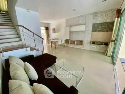 Spacious modern living room with elegant staircase and stylish decor