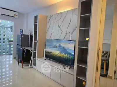 Modern living room with sleek TV setup and stylish storage cabinets
