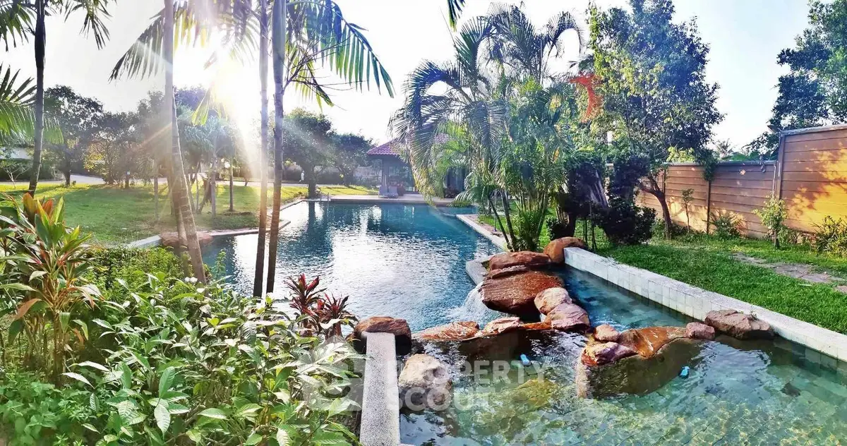 Luxurious garden with a stunning pool and lush greenery, perfect for relaxation and leisure.