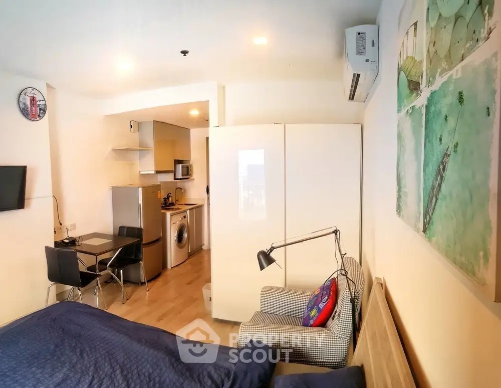 Modern studio apartment with compact kitchen and cozy living area, ideal for urban living.
