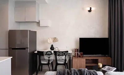 Modern living room with sleek furniture and stylish decor, featuring a compact dining area and contemporary appliances.