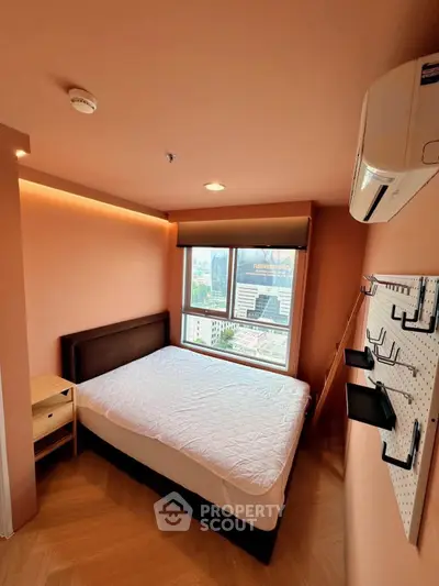 Cozy bedroom with city view, featuring modern air conditioning and stylish decor.