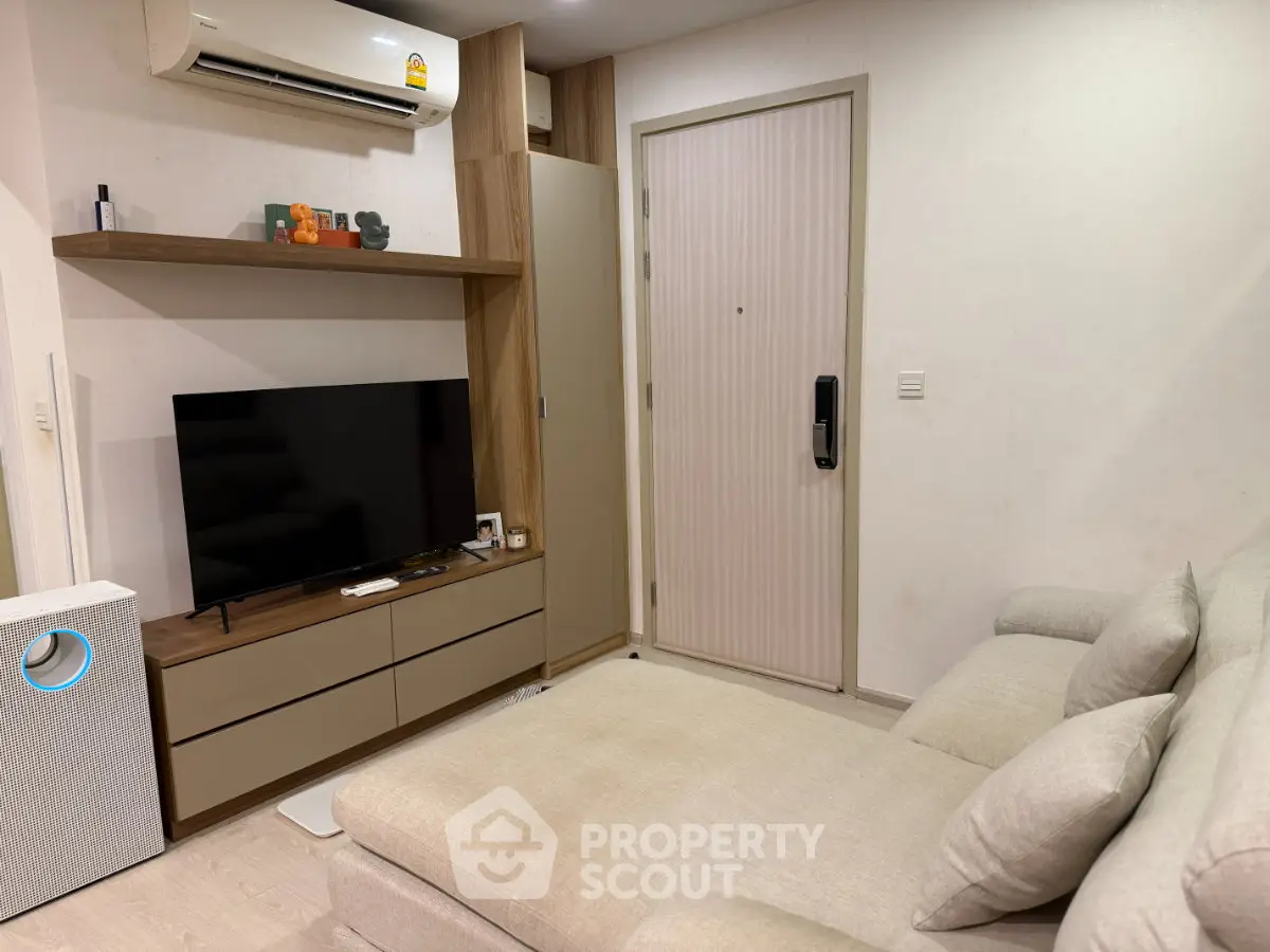 Modern living room with sleek furniture and air conditioning, perfect for cozy relaxation.