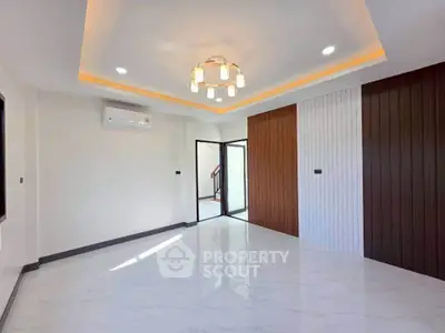 Spacious modern living room with elegant lighting and stylish wall paneling