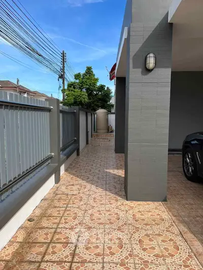 Spacious outdoor walkway with tiled flooring and modern exterior design.