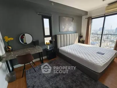 Modern bedroom with city view, stylish decor, and natural light