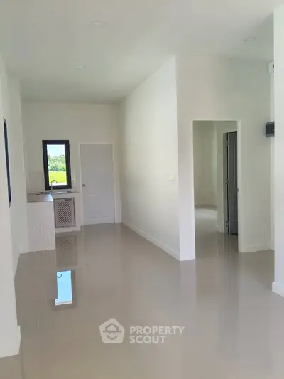 Spacious modern interior with glossy floors and natural light, ideal for customization.