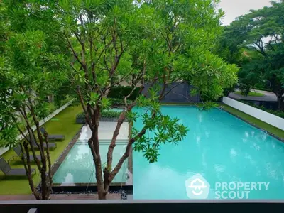 Luxurious residential pool surrounded by lush greenery for serene living.