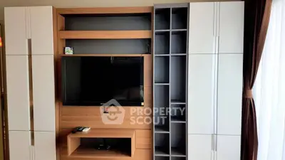 Modern living room with sleek entertainment center and natural light