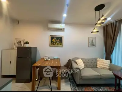 Chic living room with modern decor, cozy sofa, and stylish lighting in a contemporary apartment.