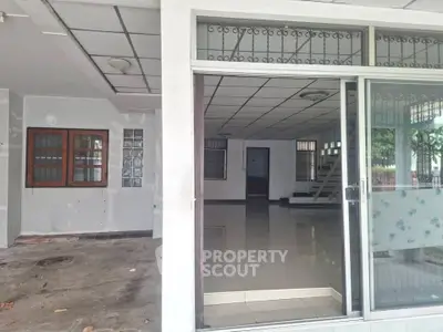 Spacious open-plan living area with sliding glass doors and tiled flooring, ideal for modern living.