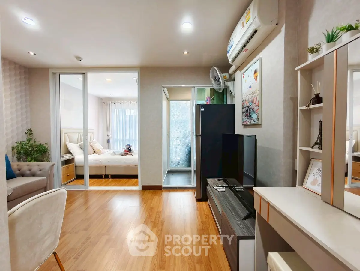 Modern living room with wooden flooring and stylish decor in a cozy apartment.