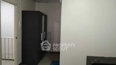 Compact storage room with wardrobe and minimal decor