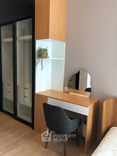 Modern bedroom with stylish wooden furniture and built-in closet, perfect for urban living.