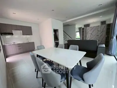 Modern open-plan living and dining area with sleek kitchen design