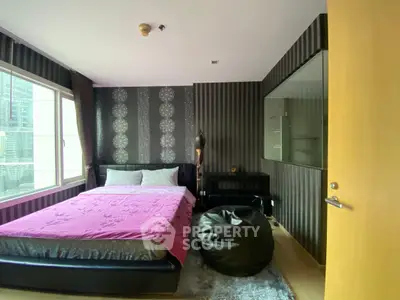 Modern bedroom with stylish decor and large window in urban apartment