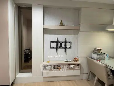 Modern living room with TV mount and dining area, featuring sleek cabinetry and contemporary decor.