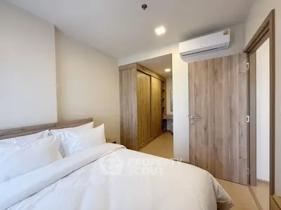Modern bedroom with cozy bedding and built-in wardrobe in a stylish apartment.