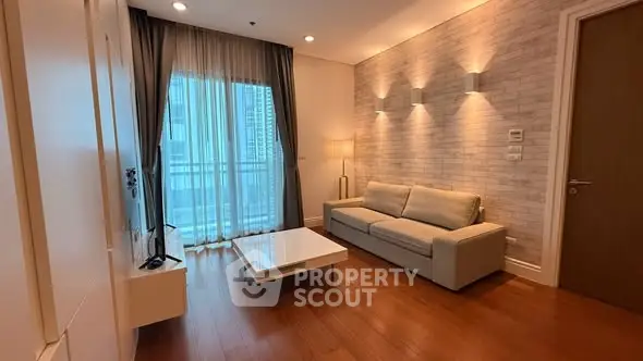 Modern living room with stylish decor and large window in a high-rise apartment.