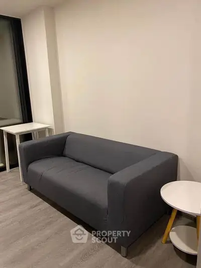 Modern living room with sleek gray sofa and minimalist decor