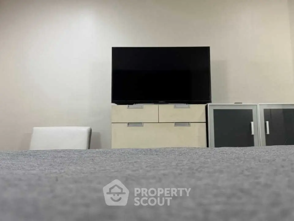 Modern living room with sleek TV setup and stylish storage units.