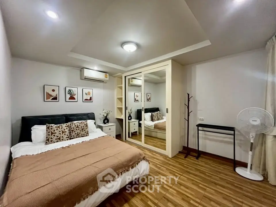 Cozy bedroom with mirrored wardrobe and stylish decor