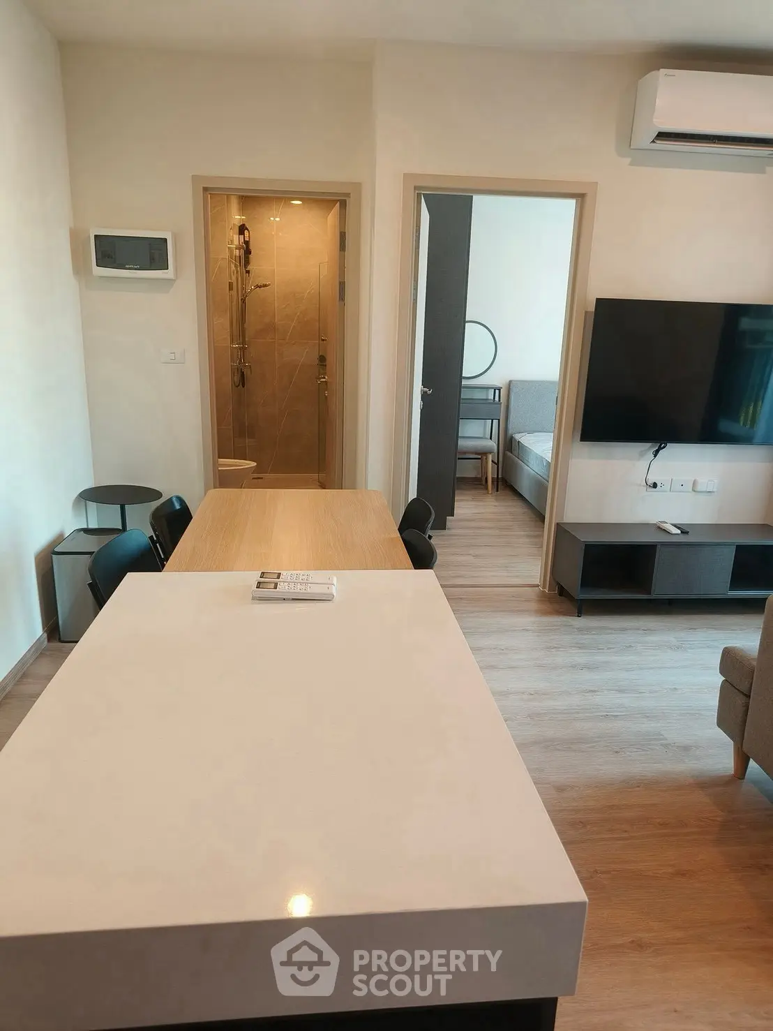 Modern apartment interior with open layout, featuring a sleek kitchen and cozy living area.