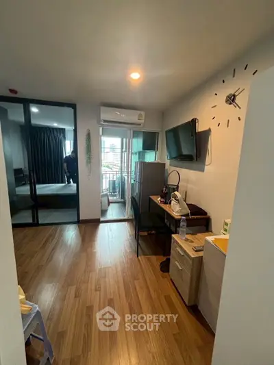 Modern apartment interior with wooden flooring and balcony view